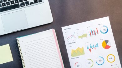 macbook pro beside spiral notebook