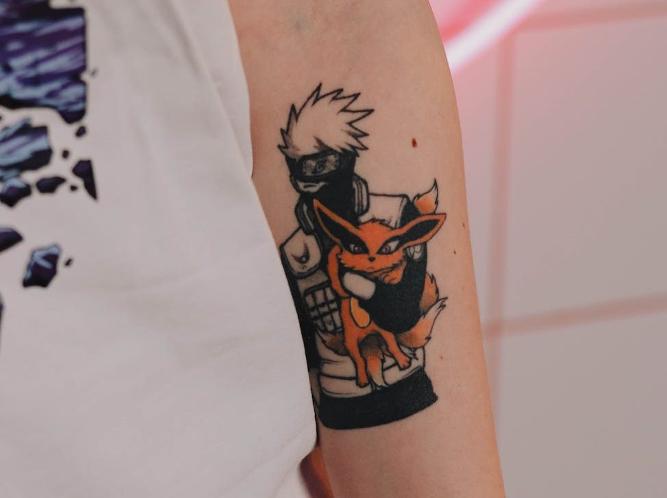 tattoo of a manga character on a mans arm
