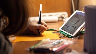 woman writing on orange paper